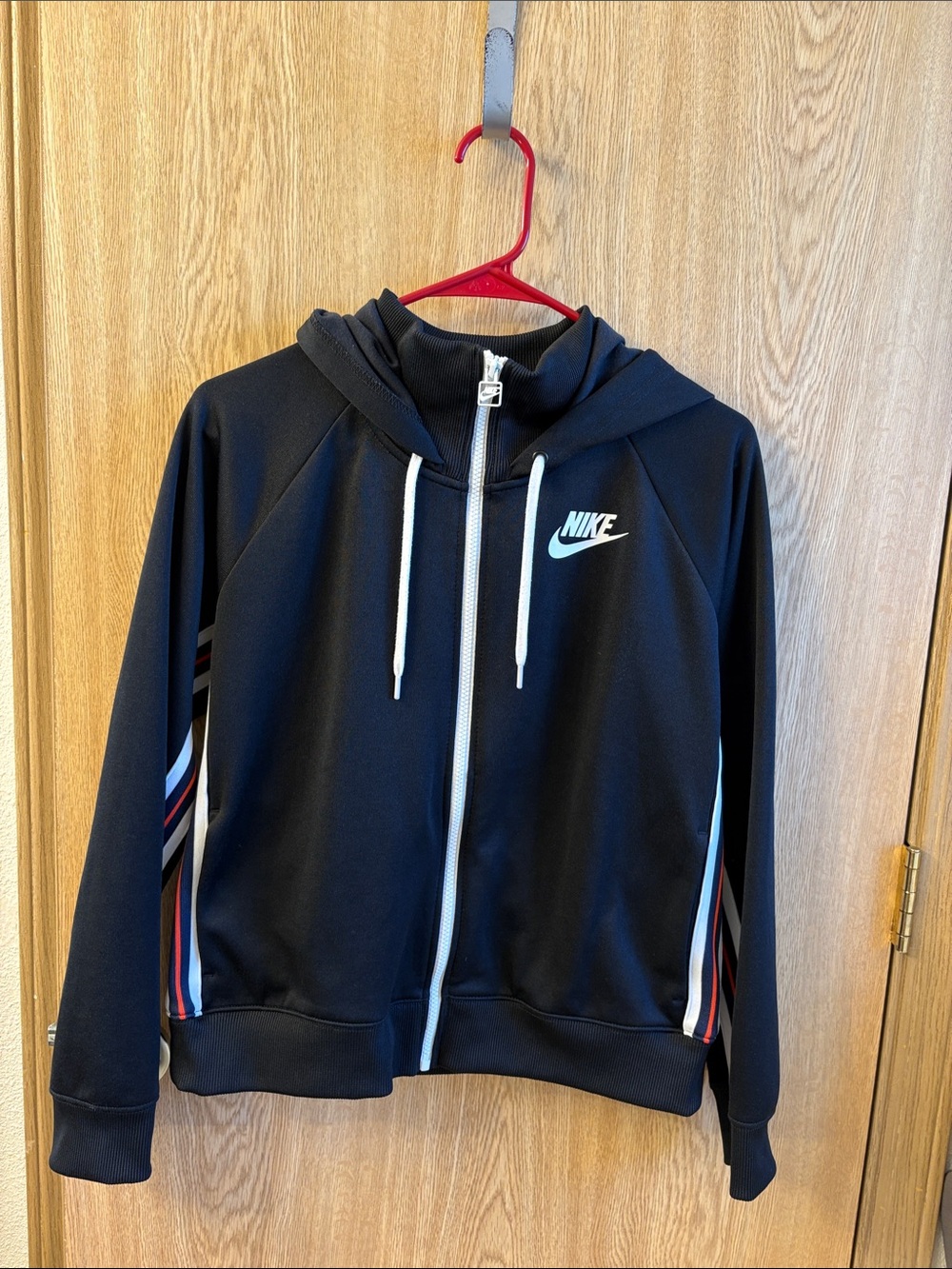 Nike Black Hoodie with White Swoosh and Red-Blue Stripe Accents